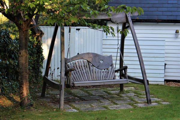 A sheltered swing seat